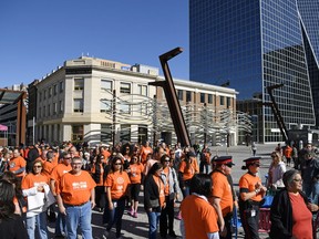 A group of people take part in walk downtown as part of an Orange Shirt Day event in Regina in 2017.