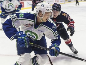 Swift Current Broncos forward Aleksi Heponiemi carries the puck while Regina Pats forward Braydon Buziak closes in during a WHL game at the Brandt Centre on Wednesday.