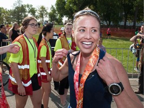 Jen Kripki of Saskatoon celebrates her first-place finish at the Queen City Marathon on Sunday.