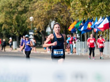 Jen Kripki, first place woman finisher in the full marathon portion of the Queen City Marathon, sprints the last hundred metres to cross the finish line in front of the Conexus Arts Centre in Regina, Saskatchewan on September 10, 2017.
