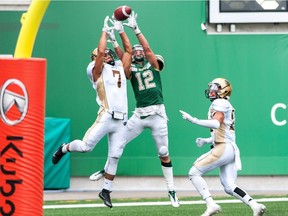 Jayden McKoy, 7, of the University of Manitoba Bisons makes an end-zone interception of a pass intended for the University of Regina Rams' Thomas Huber, 12, on Saturday at Mosaic Stadium.