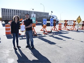 Balgonie volunteer fire firefighter Jesse Edwards, right, hands NDP Leader Nicole Sarauer a petition about the closure of Main Street connecting to the Trans-Canada Highway  in Balgonie.