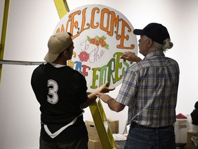 Mustafa Alabssi (left) and Allard Thomas help install The Deaf Forest. The exhibition opens Friday at the Dunlop Art Gallery.