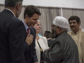 Prime Minster Justin Trudeau, left, shakes hands with Imam Sheikh Ilya Sidyot during Eid al-Adha at Prairieland Park in Saskatoon, Friday, September 1, 2017. THE CANADIAN PRESS/Liam Richards ORG XMIT: LDR101
Liam Richards,