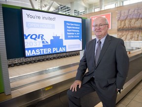 Ken Waschuk, chairman and acting CEO of the Regina Airport Authority, stands near a baggage carousel.