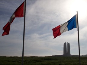 A Canadian flag can be seen blowing alongside a French flag at the Vimy Ridge Memorial in France in 2016. Ten students from the northern community of La Loche are currently fundraising so they can tour several historical sites in Europe as a part of a project aimed at teaching them more about Canada's contributions to the World War efforts and the important role Aboriginal soldiers played during WWI and WWII. (Mackenzie Graham/Supplied)