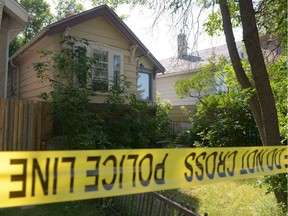 Police tape surrounds a house at 2065 McDonald St. in Regina on Saturday Aug. 6, 2016.