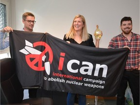 Nuclear disarmament group ICAN (International Campaign to Abolish Nuclear Weapons) co-ordinator Daniel Hogstan (left), executive director Beatrice Fihn and her husband Will Fihn Ramsay pose with a banner bearing the group's logo after ICAN won the Nobel Peace Prize for its decade-long campaign to rid the world of the atomic bomb.