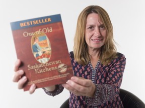 Amy Jo Ehman holds her book Out of Old Saskatchewan Kitchens, which the Saskatchewan Library Association has chosen for the 2018 One Book One Province.