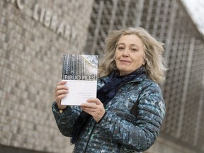 Susan Birley, history book liaison for Friends of the Regina Public Library, holds up a copy of a book she co-wrote called Biblio Files: A History of the Regina Public Library.