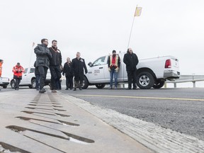 Regina Bypass Partners CEO Guillaume Dubois, third from left, and others walk on the recently completed first phase of the project. Bypass construction between Balgonie and Highway 33 is now complete, according to a government news release.