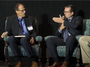 Mike Marsh, SaskPower president and CEO, right, speaks while Jeff Erikson, general manager of client engagement of the Global CCS Institute, looks on during the Global CCS Symposium held at the Hotel Saskatchewan.