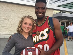 Saskatchewan Roughriders receiver Duron Carter, right, has treated fans like gold — according to columnist Rob Vanstone. Carter is shown posing with 12-year-old cancer survivor Paige Hansen earlier this season. Carter gave Hansen a football with which he made a highlight-reel catch.