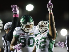 Spencer Moore, 80, and Cameron Marshall, 32, celebrate a Saskatchewan Roughriders touchdown Friday in Calgary.