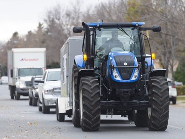 A tractor pulling a trailer full of donated food makes its way toward the next stop during the annual FCC Drive Away Hunger tour for the Regina Food Bank.