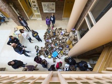 Students, teachers and FCC volunteers gather around bags of donated food at W.S. Hawrylak School during the annual FCC Drive Away Hunger tour for the Regina Food Bank.