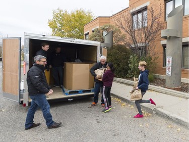 Students and FCC volunteers load donated food into a trailer at W.S. Hawrylak School during the annual FCC Drive Away Hunger tour for the Regina Food Bank.