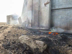 A grain bin smoulders and smokes near Burstall. The area suffered a wildfire on Tuesday night.