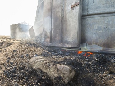 A grain bin smoulders and smokes near Burstall. The area suffered a wild fire on Tuesday night.