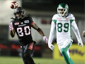 Calgary Stampeders Marken Michel is unable to make the catch in front of Duron Carter of the Saskatchewan Roughriders during CFL football on Friday, October 20, 2017.