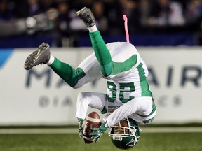 The Roughriders' Christion Jones flips into the end zone to complete a punt-return touchdown Friday against the host Calgary Stampeders.