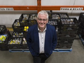 Steve Compton, CEO of Regina Food Bank, stands in front of a food storage area. The Regina Food Bank launched its 31st annual food drive. On Oct. 14, residents can leave Food Drive grocery bags on their front door steps between 9 a.m. and 5 p.m. for pickup by various youth groups and volunteer organizations.