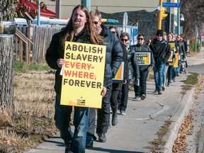 Devon Hill (front) leads the Freedom Catalyst Regina A21 Walk for Freedom along Victoria Avenue on Saturday.