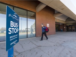 Betty Aitken of Medicine Hat walks by a Greyhound Bus sign at the Regina International Airport.