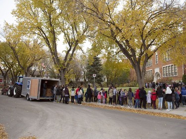 Students of Davin School formed a human chain to transfer donated food from the school to the Farm Credit Canada collection tractor  as part of the annual FCC Drive Away Hunger tour in Regina.