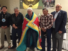 Senator Roland Crowe of the Federation of Sovereign Indigenous Nations, centre, was honoured Thursday at a celebration of the 25th Anniversary of signing the Treaty Land Entitlement framework agreement. Chief Bobby Cameron, Elder William Ratfoot, Elder Barney Tipewan and Vice-Chief Dutch Lerat (l to r) presented the star blanket October 19, 2017 in Saskatoon. Betty Ann Adam/Saskatoon StarPhoenix