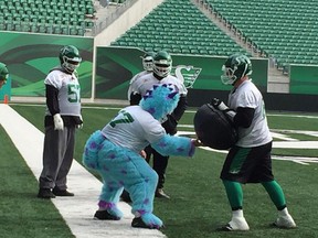 Saskatchewan Roughriders centre Dan Clark takes part in practice on Tuesday while dressed up as Sulley from the movie Monsters Inc. Some members of the Riders took to the field in costume for Halloween. Photo by Murray McCormick.