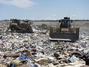 Heavy equipment moves trash around at the Regina landfill.