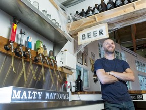 Aaron Brownlee, stands at the bar at Malty National. Brownlee is the brewery's first full-time employee.