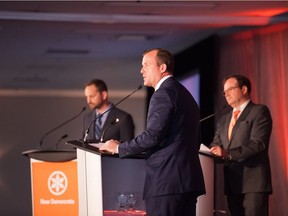 NDP leadership candidates Trent Wotherspoon (centre) and Ryan Meili (left) face off in a debate at the Queensbury Convention Centre in Regina on Oct. 28, 2017.