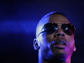 FILe - In this April 18, 2015 file photo, rapper Nelly preforms on stage during a Corner Block Party concert at Auburn University in Auburn, Ala. Police have arrested rapper Nelly after a woman said he raped her in a town outside Seattle, an accusation the Grammy winner's attorney staunchly denies. Auburn police spokesman Commander Steve Stocker said officers arrested Nelly, whose real name is Cornell Iral Haynes Jr., early Saturday, Oct. 17, 2017 in his tour bus at a Walmart. (AP Photo/Brynn Anderson, File)