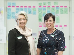 Tricia Engel, director of Palliative Care Services with the Regina Qu'Appelle Health Region, with Tammy Thompson, program manager, stand in front of a colour-coded patient care schedule at Palliative Care Services at the Pasqua Hospital. The palliative care system was recently redesigned to provide more responsive and flexible services to its clients.