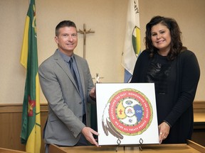 Sean Chase (left), superintendent of education services, and Joanna Landry, First Nations, Metis and Inuit co-ordinator, are two of the Regina Catholic School Division staff involved in the creation of a new logo representing the school division's commitment to truth and reconciliation.