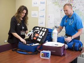 Nurse practitioner Kim Lato and paramedic Donovan Ljubic  go through medical supplies they take on a house call to a senior's residence.  They are two of the 33 members of the Seniors House Calls program.