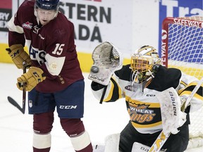 Regina Pats centre Braydon Buziak tries to screen Brandon Wheat Kings goalie Logan Thomson during first-period WHL action at the Brandt Centre on Wednesday.