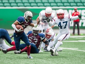 Victor St-Pierre Laviolette, left, rushes for some of the 169 yards he gained Sunday against the visiting Calgary Colts.