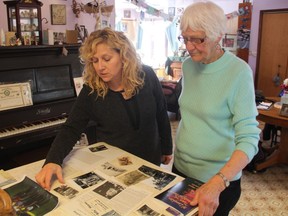 Margaret Leepart, left, and her mother, Margaret Joan Looby, look over some old photos of Lieut. William Hayes at Looby's home outside of Bjorkdale, Sask. on Nov. 6, 2017. About 20 of his relatives recently took a battlefield tour of many of the sites where he fought during the First World War.