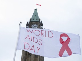 The World AIDS Day flag flies on Parliament Hill in Ottawa on Thursday, Dec. 1, 2016.