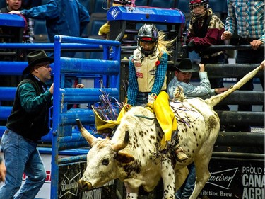 Hanna Bower, 13, of Leader hangs on tight as she starts her ride at the Steer Riding Rodeo School during Agribition on Saturday, Nov. 25, 2017, at the Brandt Centre.