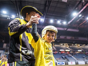 James David, six, of Kisbey raises his hand in the air after participating in the Wild Wool Ride sheep riding event for kids aged five to seven during Agribition on Saturday, Nov. 25, 2017, at the Brandt Centre.