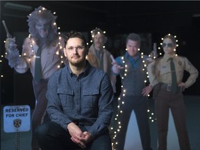 WolfCop writer and director Lowell Dean sits at The Soundstage before cardboard cutouts of Another WolfCop's cast.