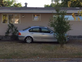 A car parked on a front yard near the University of Regina.