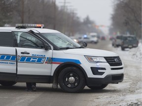 Regina Police Service vehicles block eastbound traffic on 4th Ave. at Forget St.