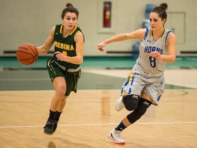 The University of Regina Cougars' Avery Pearce, left, advances the ball against the University of Lethbridge Pronghorns' Zoe Dahl on Saturday at the Centre for Kinesiology, Health and Sport.