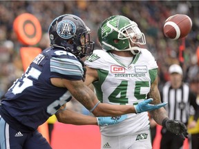 Toronto Argonauts wide receiver DeVier Posey (85) catches a touchdown pass in front of Saskatchewan Roughriders defensive back Kacy Rodgers II (45) during the first half of the CFL Eastern final, Sunday, November 19, 2017 in Toronto.