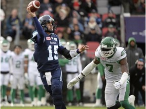 Toronto Argonauts quarterback Ricky Ray throws the football under pressure from Saskatchewan Roughriders defensive end Willie Jefferson during Sunday's CFL East Division final.